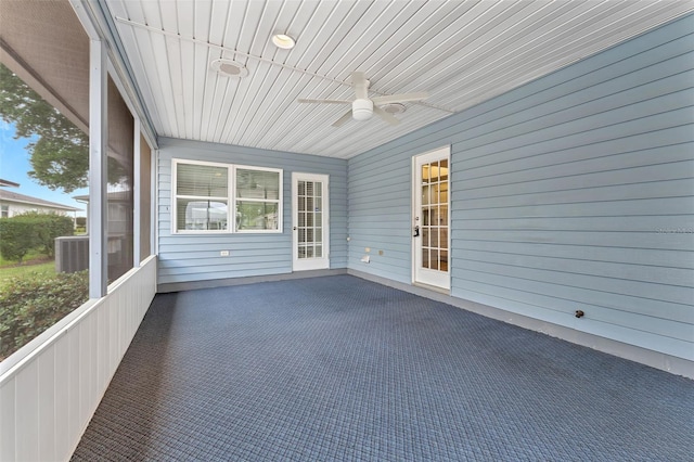 unfurnished sunroom with ceiling fan and a wealth of natural light