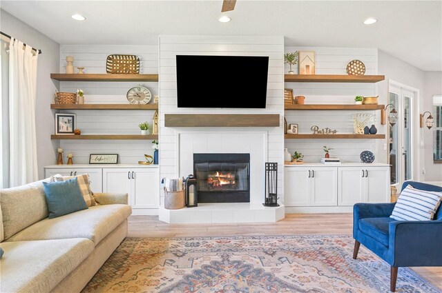 living room with a fireplace and light hardwood / wood-style flooring