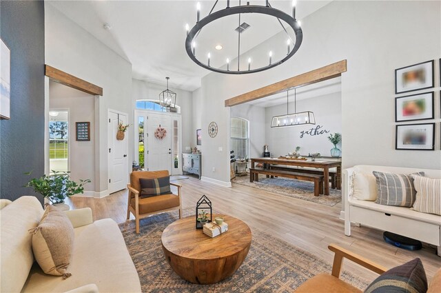 living room featuring a towering ceiling and wood-type flooring