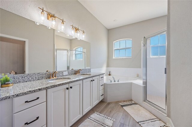 bathroom with hardwood / wood-style floors, vanity, and separate shower and tub