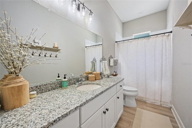 bathroom featuring hardwood / wood-style floors, vanity, and toilet