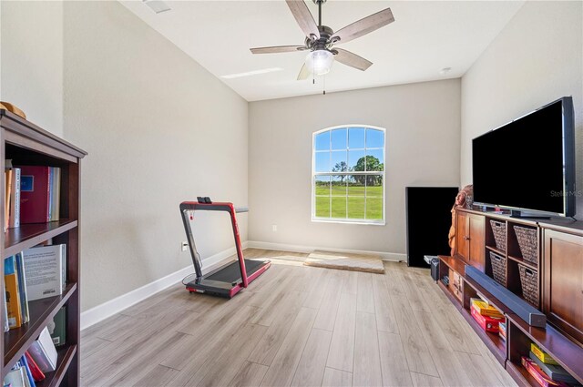 workout area with ceiling fan and light hardwood / wood-style flooring