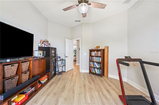 workout room featuring ceiling fan and light hardwood / wood-style floors