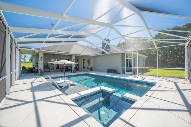 view of pool with an in ground hot tub, glass enclosure, and a patio