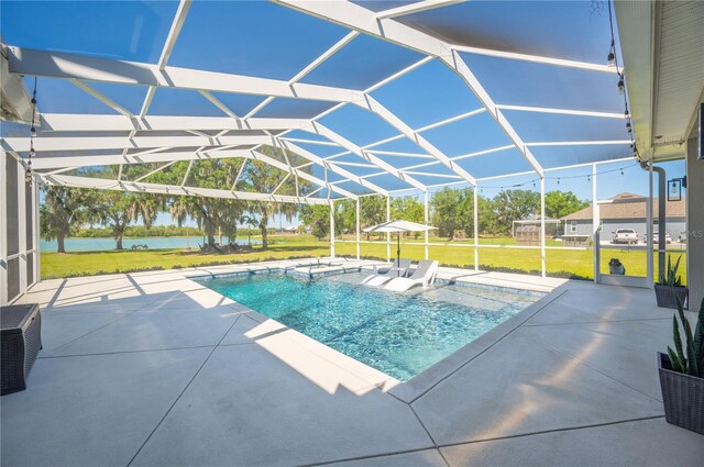 view of swimming pool with a lanai, a patio area, and a yard