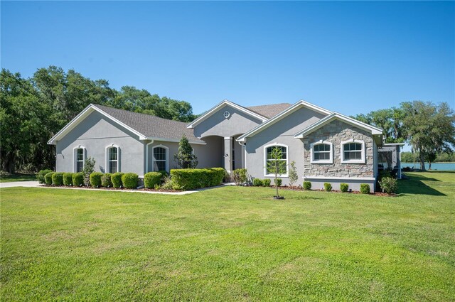 ranch-style home featuring a front yard