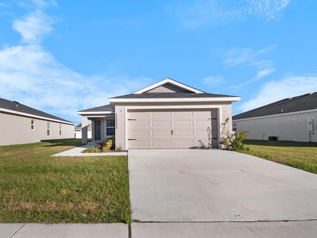 ranch-style home with a front lawn and a garage