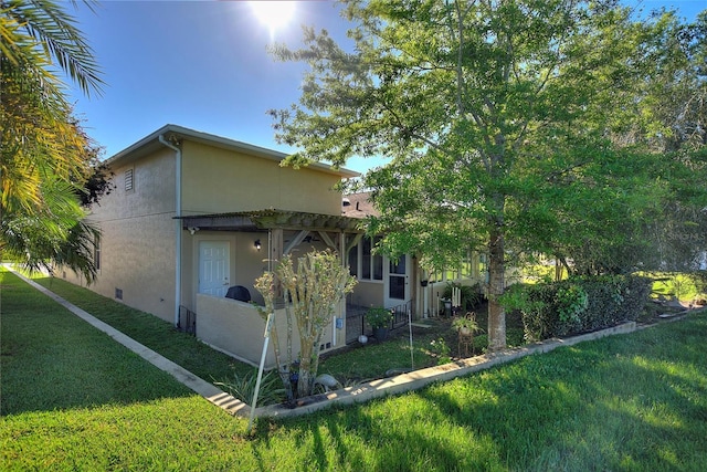 view of side of home featuring a lawn