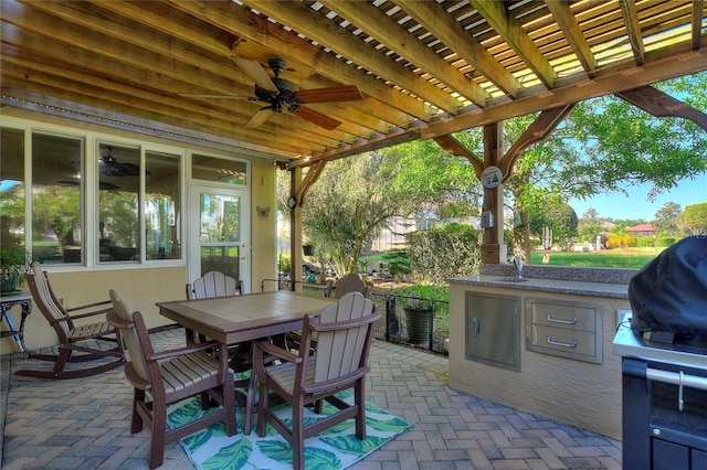 view of patio / terrace with ceiling fan, a pergola, and exterior kitchen