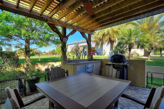 view of patio featuring area for grilling and a pergola