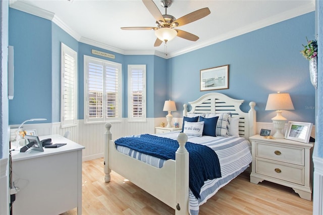 bedroom featuring crown molding, light wood-type flooring, and ceiling fan