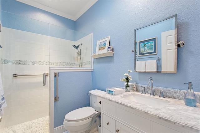 bathroom featuring tiled shower, oversized vanity, and toilet