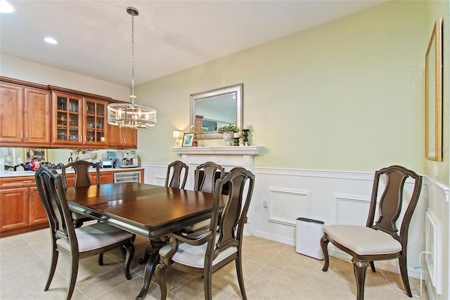 tiled dining space featuring a notable chandelier