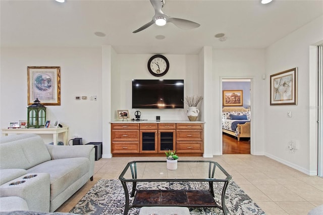 living room with ceiling fan and light tile flooring