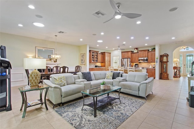 living room with ceiling fan and light tile flooring