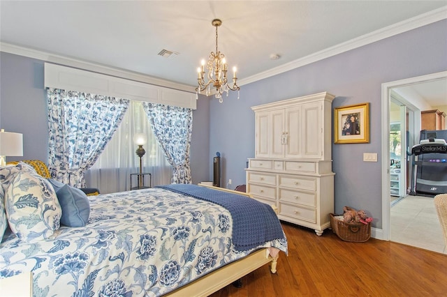 bedroom with a notable chandelier, ornamental molding, and wood-type flooring