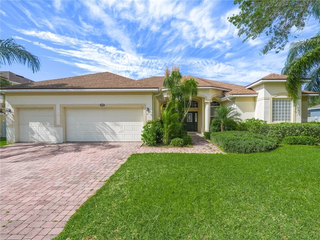 view of front of house with a front yard and a garage