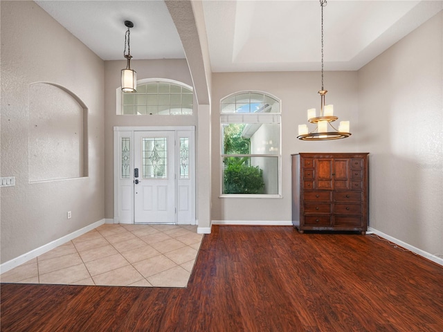 entryway featuring a chandelier and tile floors