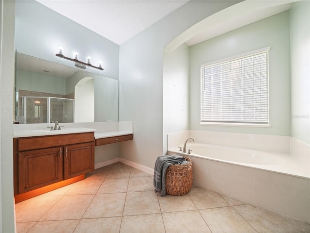 bathroom featuring independent shower and bath, tile flooring, and vanity