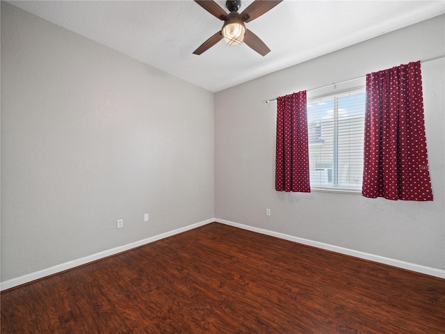 empty room featuring dark hardwood / wood-style flooring and ceiling fan