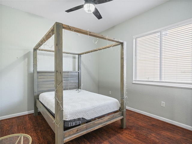 bedroom with multiple windows, ceiling fan, and dark hardwood / wood-style flooring