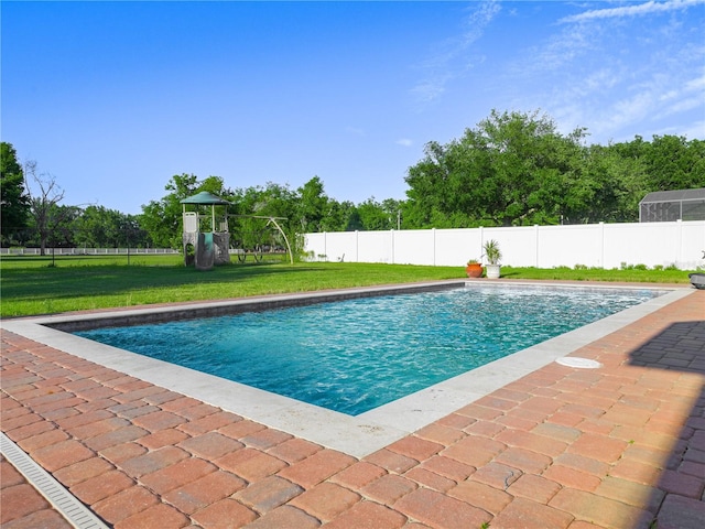 view of swimming pool with a playground and a lawn