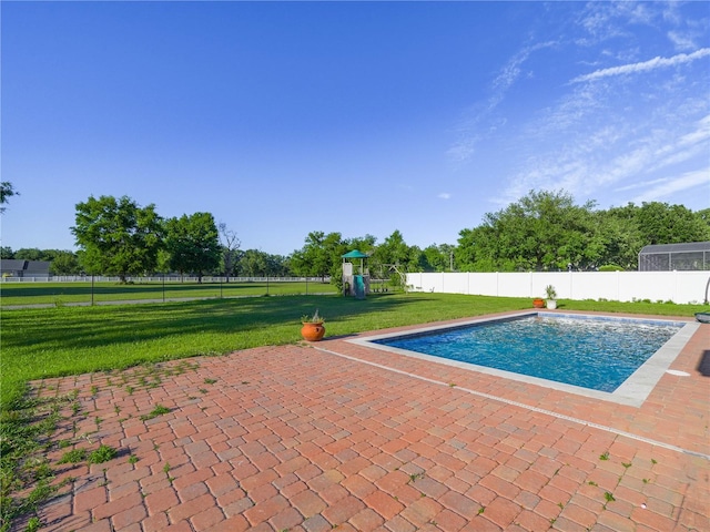 view of pool with a yard, a playground, and a patio area