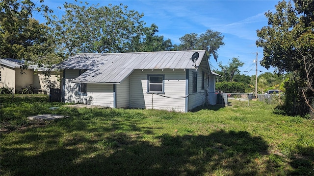 view of outbuilding featuring a lawn