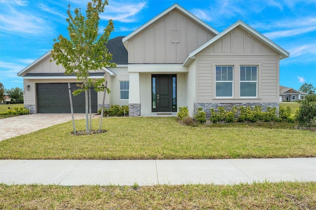 view of front of property with a garage and a front yard