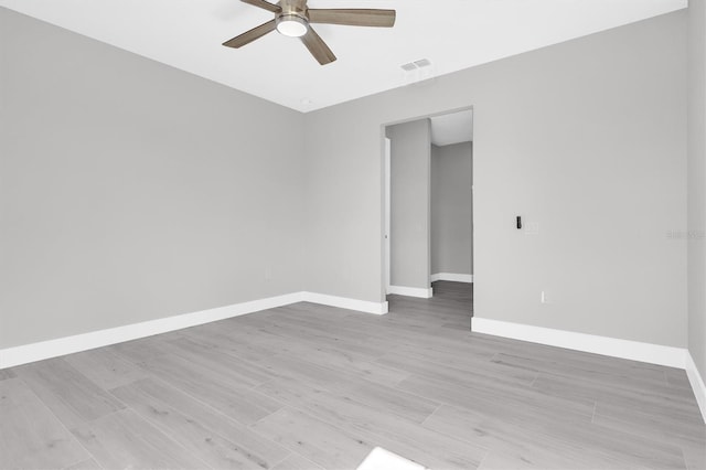 spare room featuring light hardwood / wood-style floors and ceiling fan