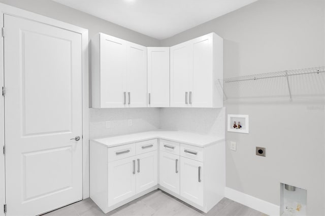 washroom featuring washer hookup, hookup for an electric dryer, and cabinets