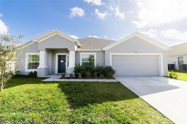 ranch-style home featuring a front lawn, a garage, and central AC