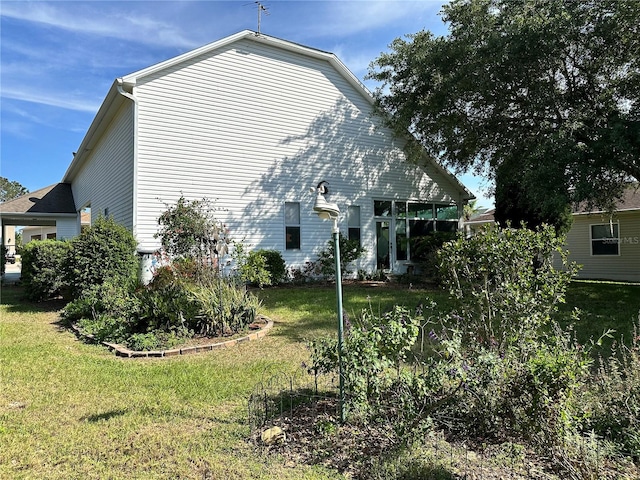 rear view of property with a yard