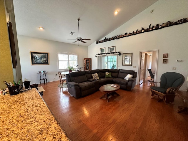 living room featuring high vaulted ceiling, ceiling fan, and dark wood-type flooring