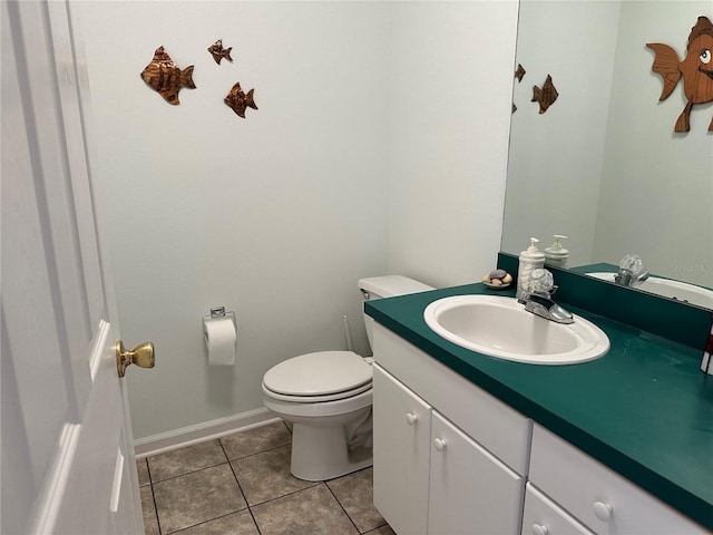 bathroom featuring large vanity, toilet, and tile flooring