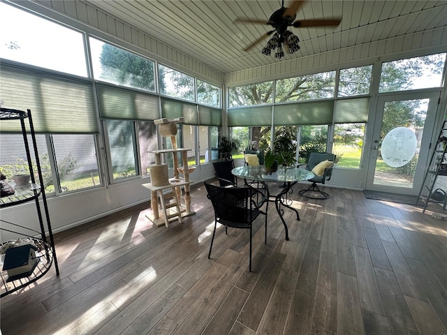 sunroom / solarium with wood ceiling, plenty of natural light, and ceiling fan