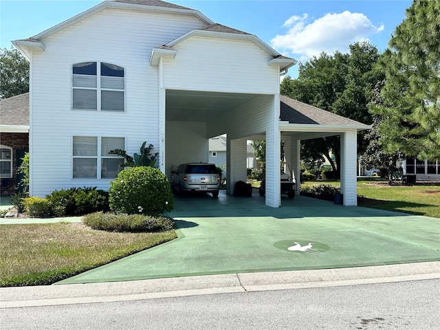 view of front facade featuring a front lawn and a carport