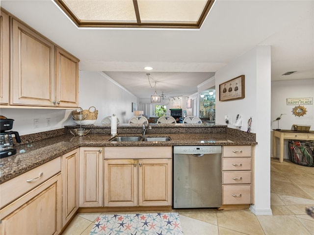 kitchen with dark stone countertops, sink, dishwasher, and light tile flooring