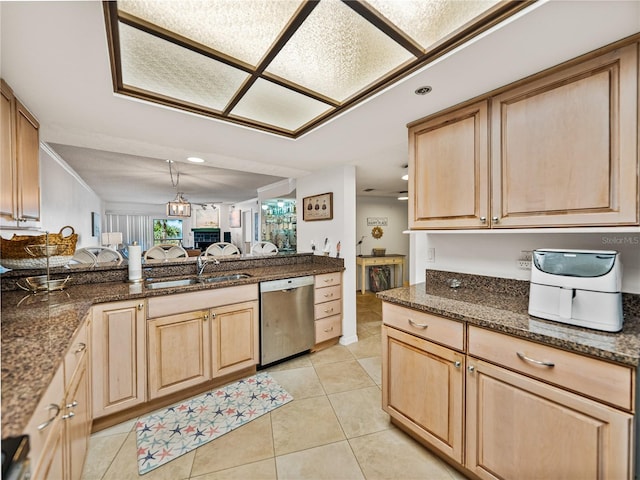 kitchen with light brown cabinets, light tile floors, sink, dishwasher, and dark stone countertops