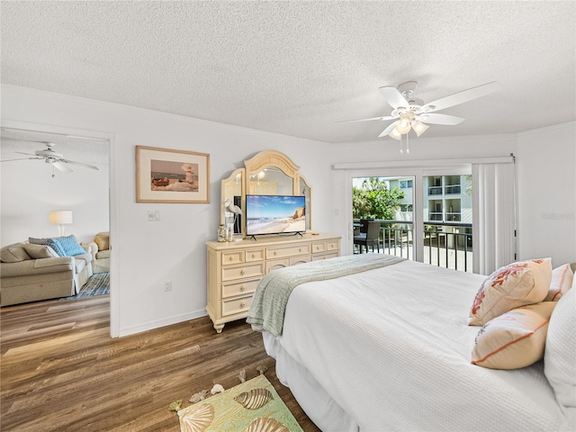 bedroom featuring access to outside, dark hardwood / wood-style floors, ceiling fan, and a textured ceiling