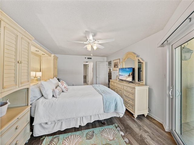 bedroom with dark wood-type flooring, ceiling fan, and a textured ceiling