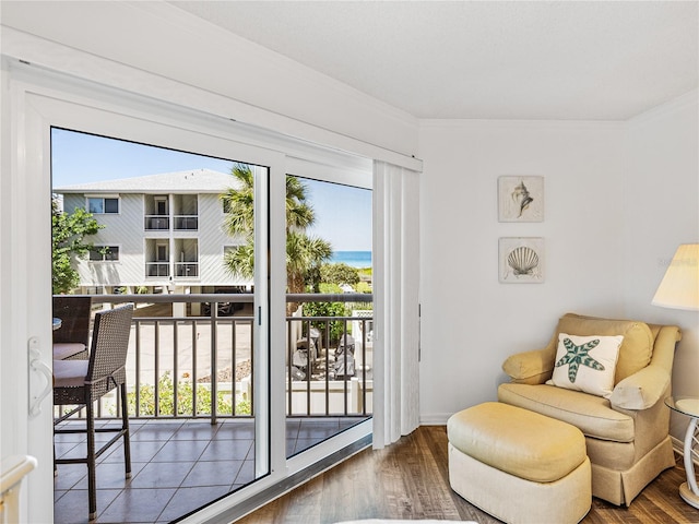 doorway to outside featuring a healthy amount of sunlight, dark hardwood / wood-style flooring, and a water view