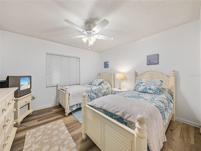 bedroom featuring ceiling fan, dark hardwood / wood-style floors, and a textured ceiling