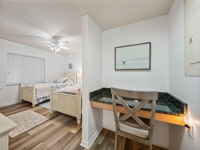 bedroom featuring a textured ceiling, ceiling fan, and hardwood / wood-style flooring