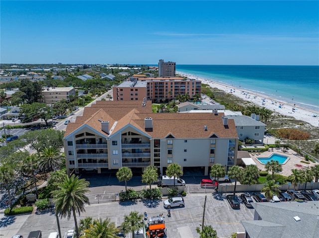 birds eye view of property featuring a water view and a beach view