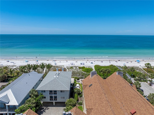 birds eye view of property with a beach view and a water view