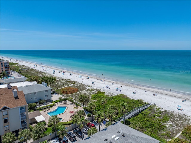 birds eye view of property featuring a view of the beach and a water view