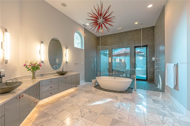 bathroom featuring a bathing tub, double vanity, and tile flooring