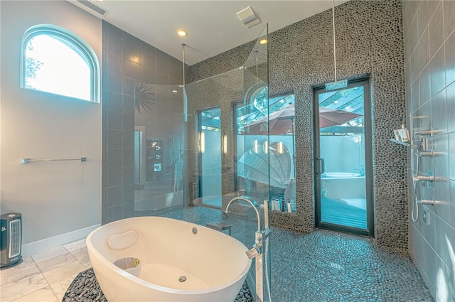 bathroom featuring independent shower and bath and tile flooring