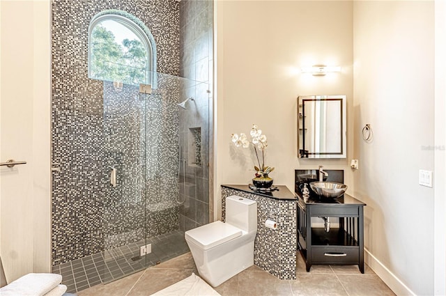 bathroom with tile flooring, walk in shower, and vanity